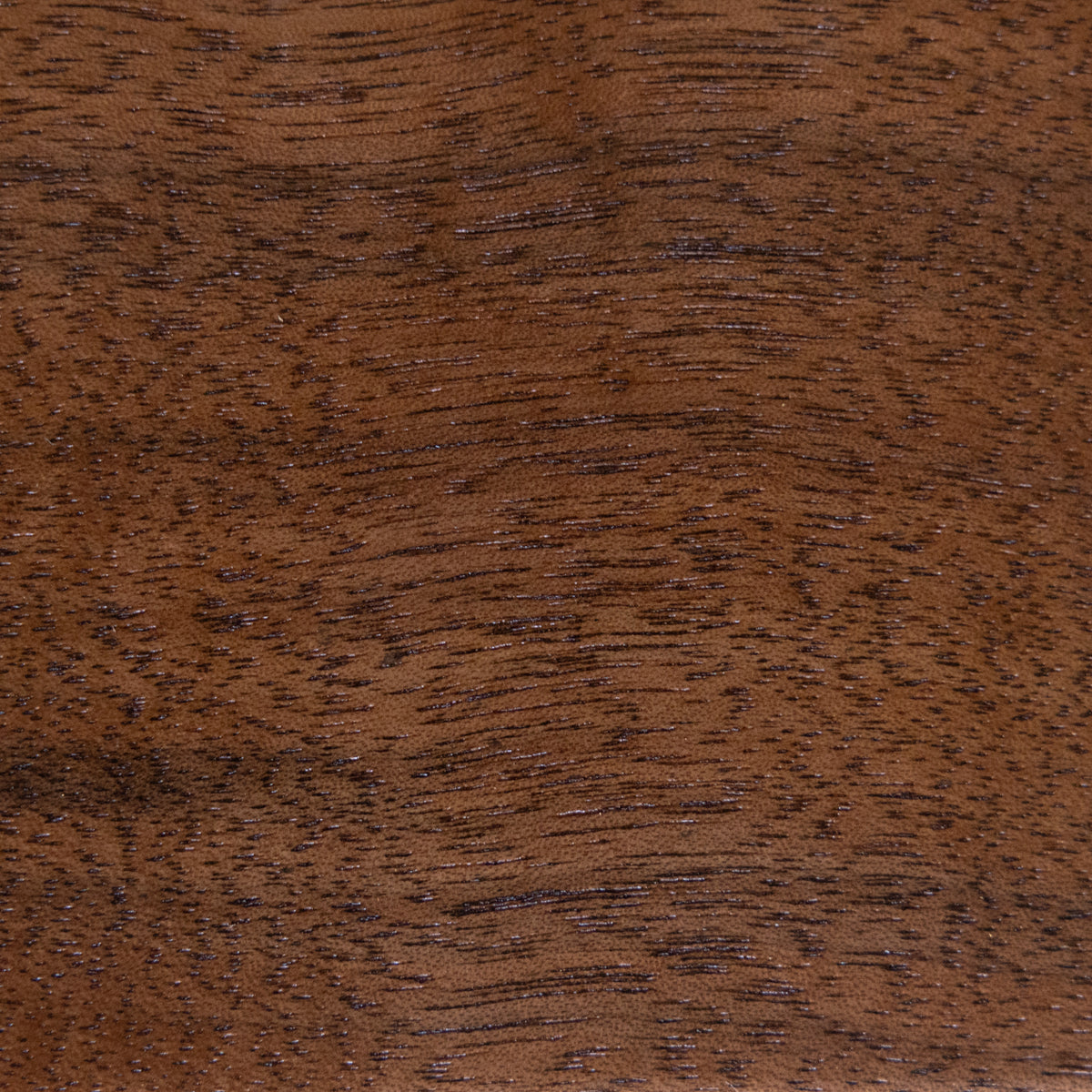 Close-up of a brown wooden surface with visible grain.